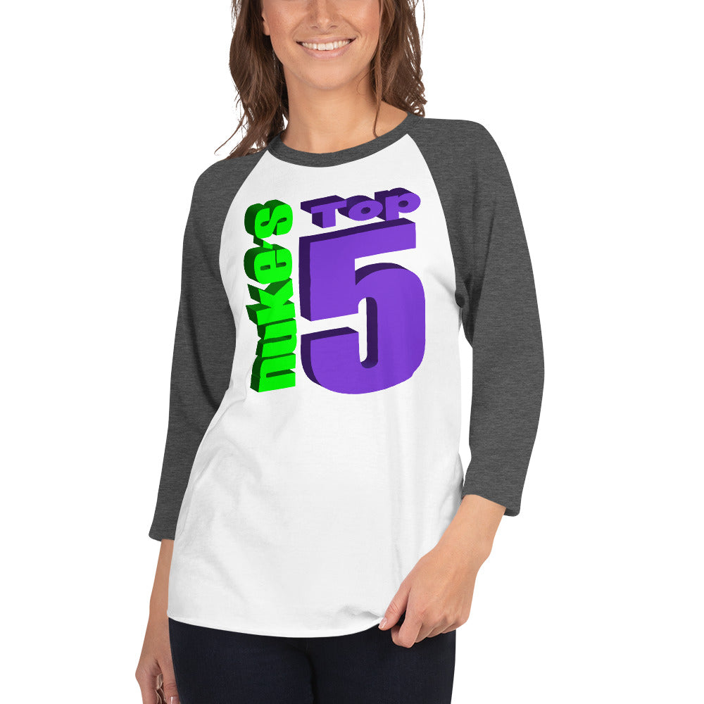 A woman wearing a Nuke's Top 5 logo white and grey baseball tee